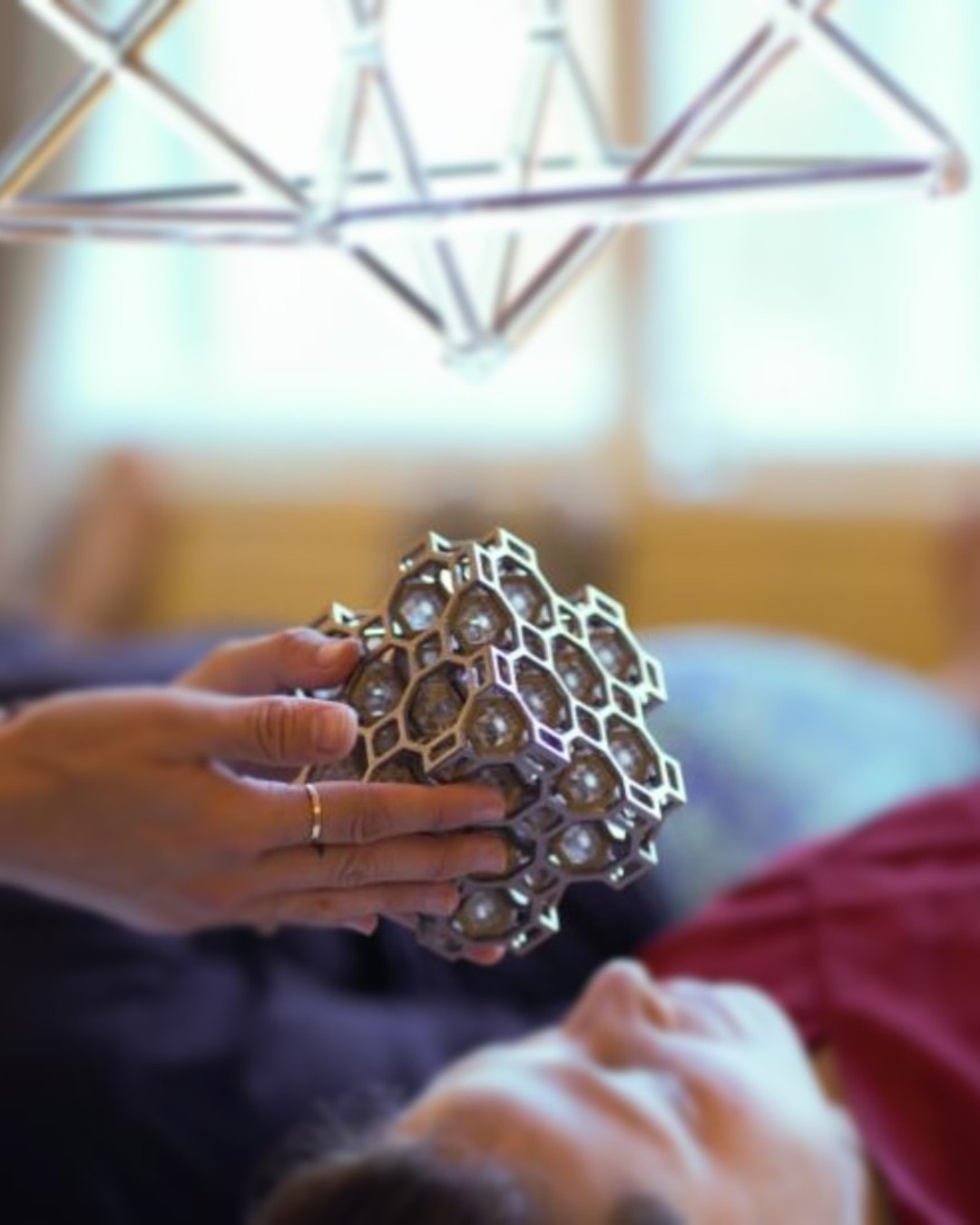 Person holding a set of 64 ARK crystals of someone's head